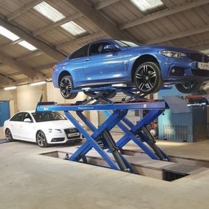 Blue BMW on scissor lift